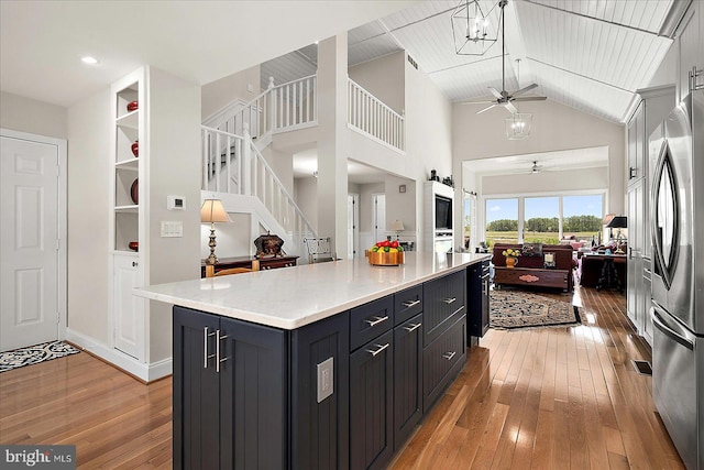 30558 Luff Ln Unit C-14, Ocean View, DE 19970 - kitchen featuring a ceiling fan, open floor plan, freestanding refrigerator, light wood-style flooring, and high vaulted ceiling