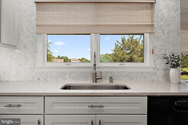 30558 Luff Ln Unit C-14, Ocean View, DE 19970 - kitchen featuring black dishwasher, a sink, tasteful backsplash, and light stone countertops