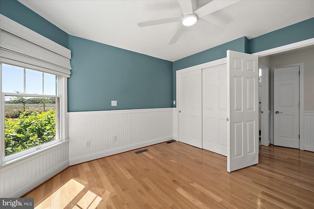 30558 Luff Ln Unit C-14, Ocean View, DE 19970 - unfurnished bedroom with wainscoting, light wood-style floors, a closet, and a ceiling fan