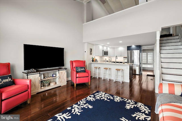 3 129th St Unit 7, Ocean City, MD 21842 - living room with wood finished floors, a towering ceiling, and stairs