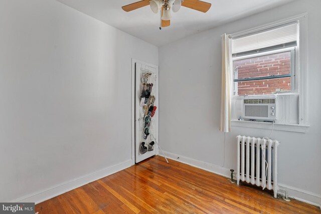 4825 3rd St NW, Washington, DC 20011 - unfurnished room featuring radiator, ceiling fan, wood finished floors, and cooling unit