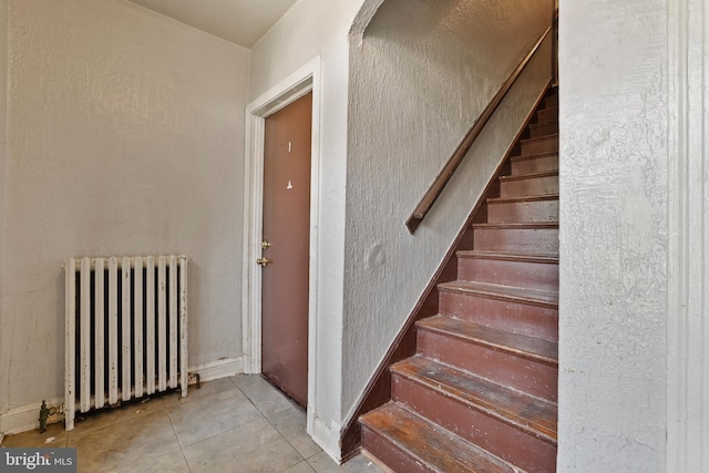 4825 3rd St NW, Washington, DC 20011 - staircase with radiator heating unit and tile patterned floors