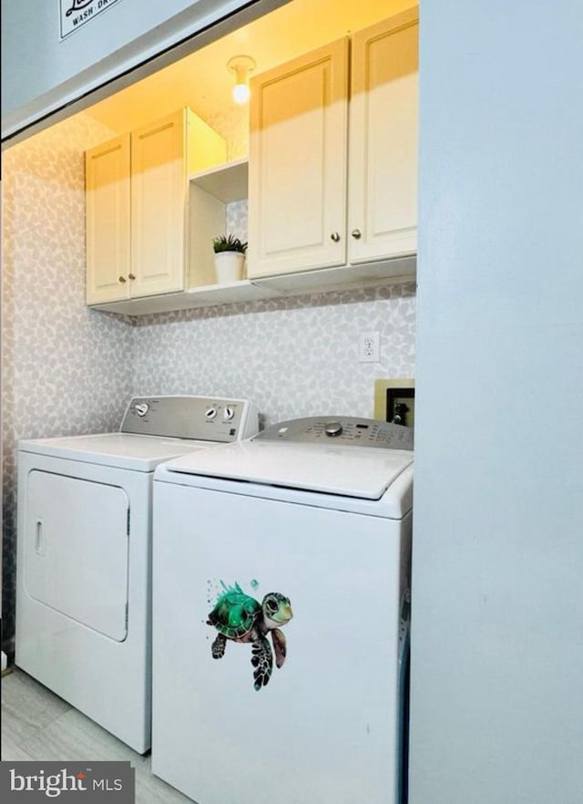 608 Tacketts Mill Rd, Stafford, VA 22556 - laundry room featuring separate washer and dryer, cabinet space, and wallpapered walls