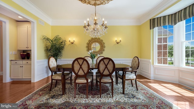 2799 Manion Way, Doylestown, PA 18902 - dining room featuring a chandelier, wood finished floors, crown molding, wainscoting, and a decorative wall