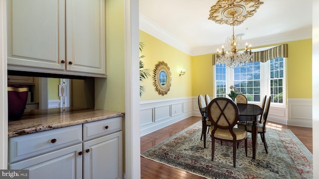 2799 Manion Way, Doylestown, PA 18902 - dining room featuring a chandelier, ornamental molding, a wainscoted wall, a decorative wall, and dark wood finished floors