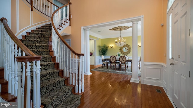 2799 Manion Way, Doylestown, PA 18902 - foyer entrance featuring decorative columns, stairway, ornamental molding, hardwood / wood-style floors, and a chandelier