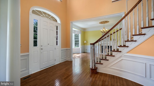2799 Manion Way, Doylestown, PA 18902 - foyer entrance featuring wainscoting, a chandelier, dark wood-type flooring, stairway, and crown molding