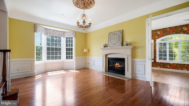 2799 Manion Way, Doylestown, PA 18902 - unfurnished living room featuring wood-type flooring, a glass covered fireplace, wainscoting, a chandelier, and crown molding