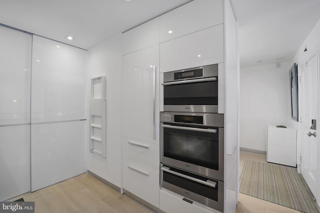 3927 Georgetown Ct NW, Washington, DC 20007 - kitchen featuring modern cabinets, stainless steel double oven, white cabinets, and light wood-style floors