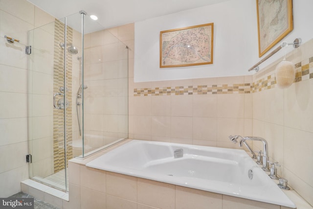 3927 Georgetown Ct NW, Washington, DC 20007 - bathroom with a shower stall, a bath, and tile walls
