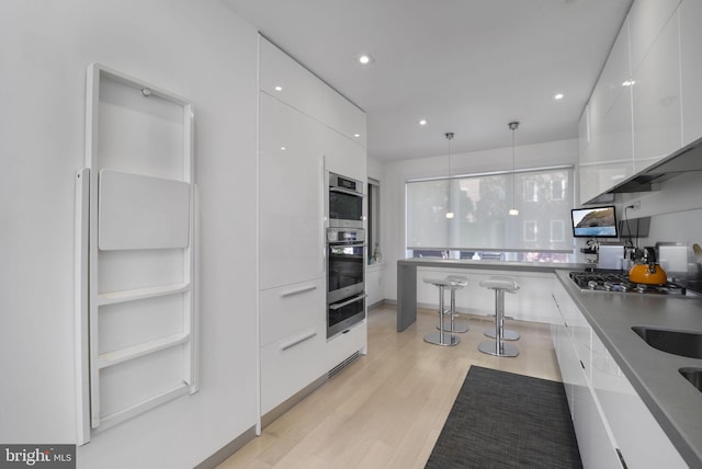 3927 Georgetown Ct NW, Washington, DC 20007 - kitchen featuring modern cabinets, white cabinetry, light wood finished floors, a warming drawer, and stainless steel appliances
