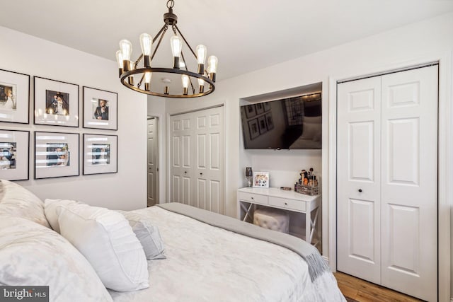2305 S Croskey St, Philadelphia, PA 19145 - bedroom with two closets, a chandelier, and wood finished floors
