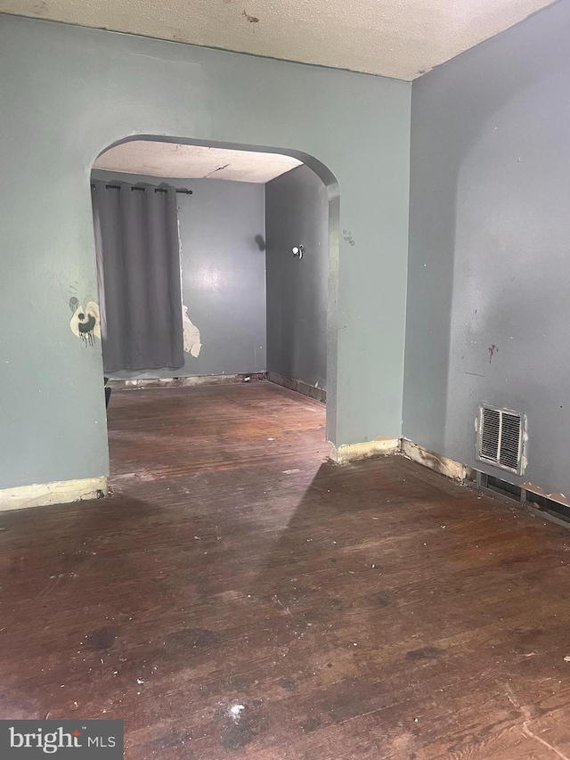 2819 Overland Ave, Baltimore, MD 21214 - spare room featuring arched walkways, hardwood / wood-style floors, and baseboards