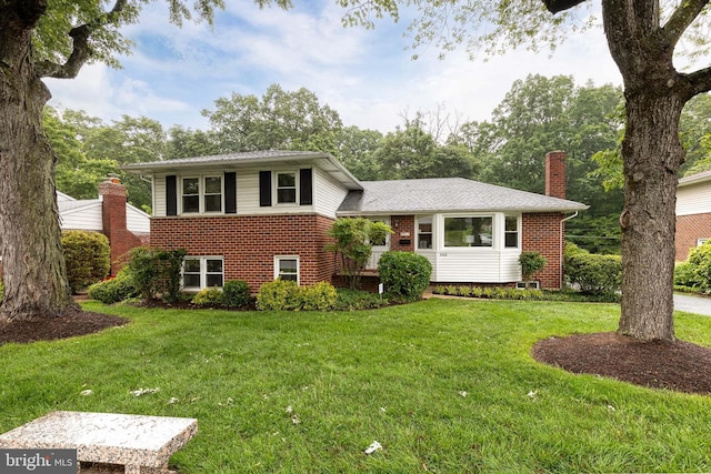522 Goucher Blvd, Baltimore, MD 21286 - split level home with a chimney, brick siding, and a front lawn