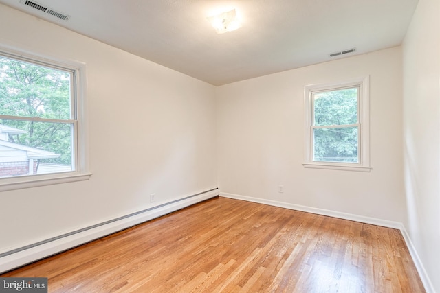522 Goucher Blvd, Baltimore, MD 21286 - unfurnished room featuring a baseboard heating unit, plenty of natural light, light wood finished floors, and baseboards