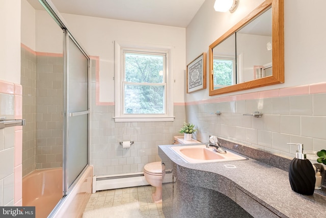 522 Goucher Blvd, Baltimore, MD 21286 - bathroom featuring a baseboard heating unit, tile walls, toilet, combined bath / shower with glass door, and vanity