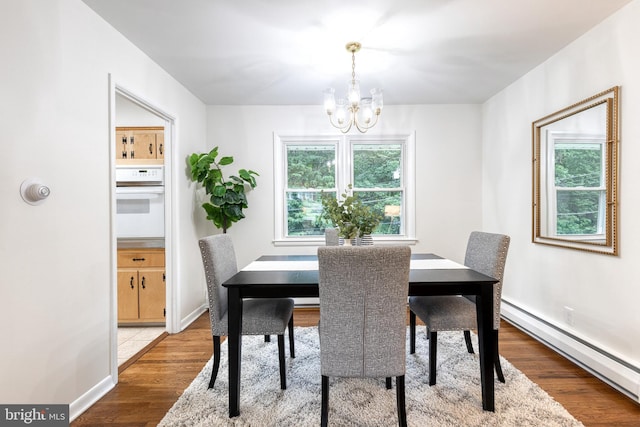 522 Goucher Blvd, Baltimore, MD 21286 - dining room with a baseboard heating unit, a chandelier, wood finished floors, and baseboards