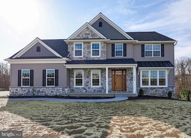 view of front of house featuring stone siding, board and batten siding, covered porch, and roof with shingles