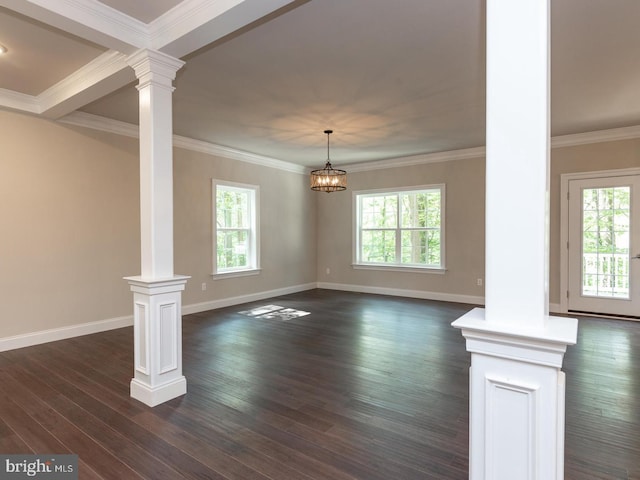 unfurnished living room featuring decorative columns, plenty of natural light, dark wood-type flooring, and crown molding