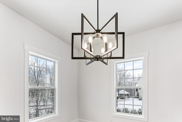 detailed view of a chandelier and baseboards