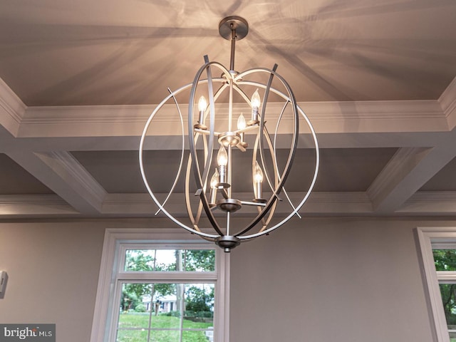 detailed view of a chandelier, ornamental molding, coffered ceiling, and beam ceiling