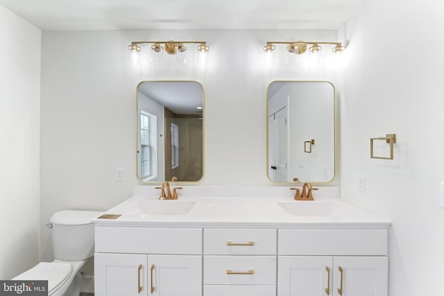 full bathroom with toilet and double vanity