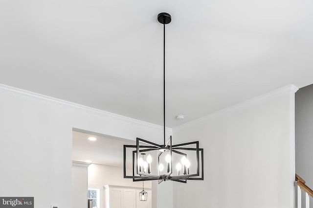 detailed view of ornamental molding, a smoke detector, a chandelier, and recessed lighting