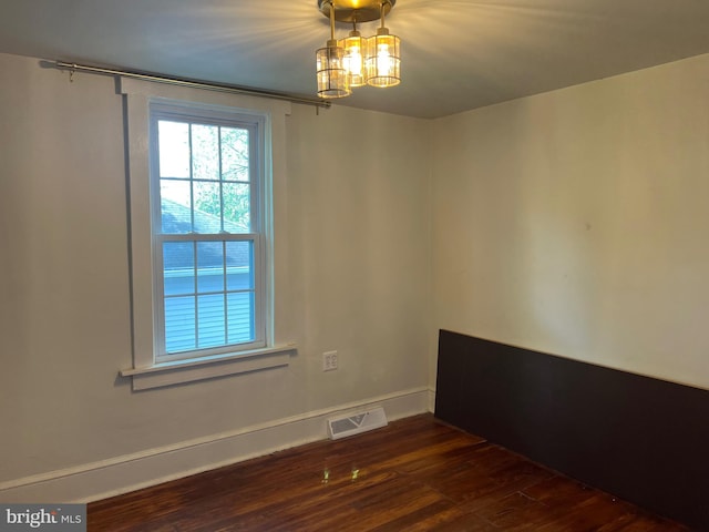 303 Johnson Ave, Upper Chichester, PA 19061 - empty room with dark wood-style flooring, a chandelier, and baseboards