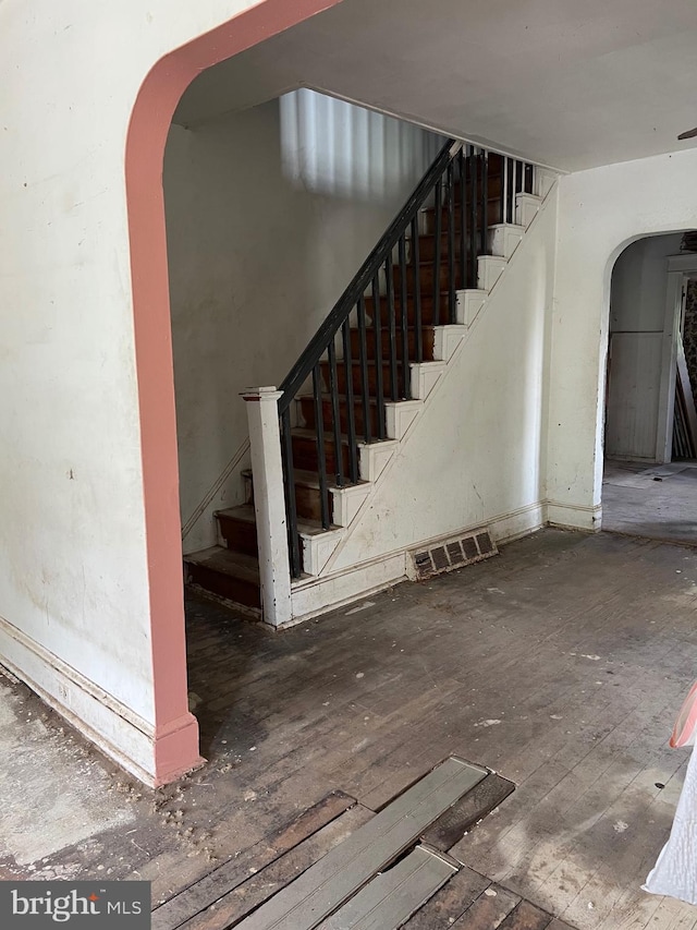 303 Johnson Ave, Upper Chichester, PA 19061 - stairway with arched walkways and wood-type flooring