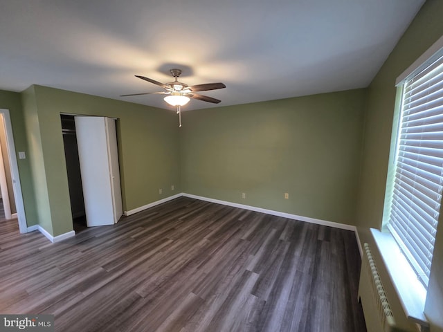 616 Sylvan Pl, Harrisburg, PA 17109 - unfurnished bedroom featuring multiple windows, radiator heating unit, dark wood-style floors, and baseboards