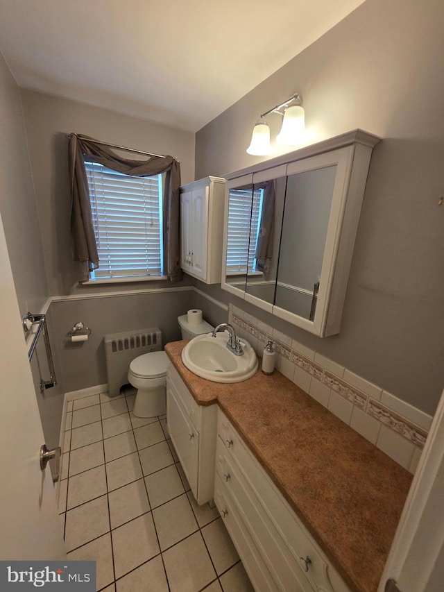 616 Sylvan Pl, Harrisburg, PA 17109 - bathroom featuring radiator heating unit, tile patterned flooring, toilet, and vanity