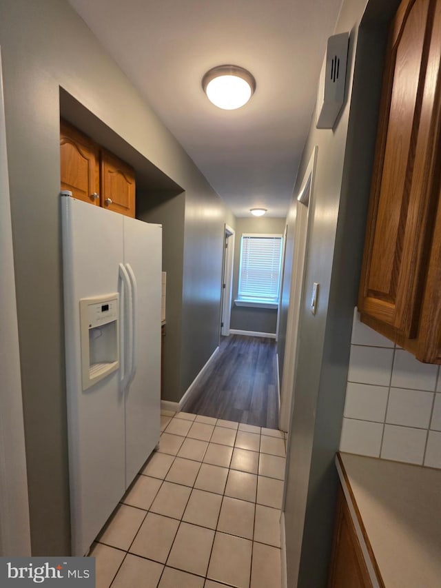616 Sylvan Pl, Harrisburg, PA 17109 - kitchen featuring white refrigerator with ice dispenser, brown cabinets, and light wood finished floors