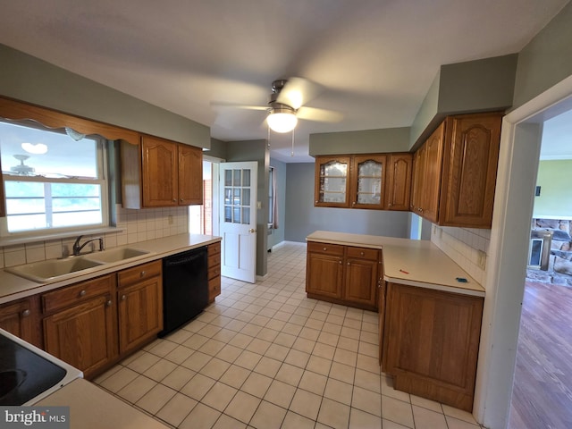 616 Sylvan Pl, Harrisburg, PA 17109 - kitchen featuring dishwasher, a sink, brown cabinets, and light countertops