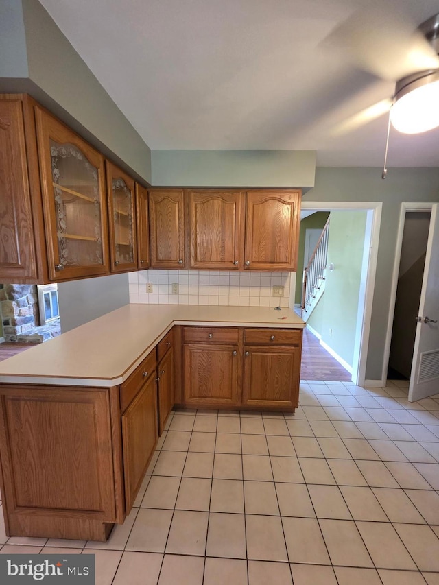616 Sylvan Pl, Harrisburg, PA 17109 - kitchen featuring brown cabinetry, light countertops, and tasteful backsplash