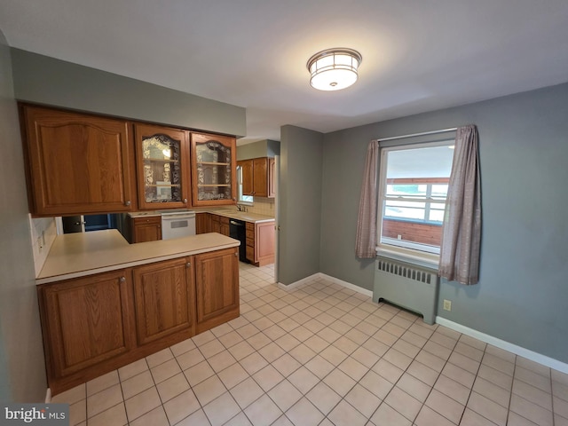 616 Sylvan Pl, Harrisburg, PA 17109 - kitchen featuring radiator heating unit, brown cabinets, light countertops, and a peninsula