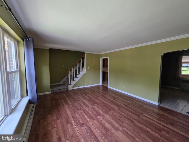 616 Sylvan Pl, Harrisburg, PA 17109 - unfurnished living room with wood finished floors, crown molding, stairs, baseboards, and radiator