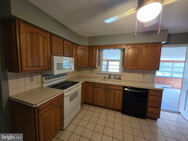 616 Sylvan Pl, Harrisburg, PA 17109 - kitchen featuring white appliances, brown cabinetry, decorative backsplash, and a sink