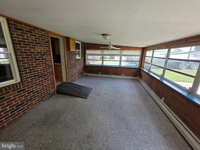 616 Sylvan Pl, Harrisburg, PA 17109 - unfurnished sunroom featuring brick wall, a baseboard radiator, a ceiling fan, carpet, and wood walls