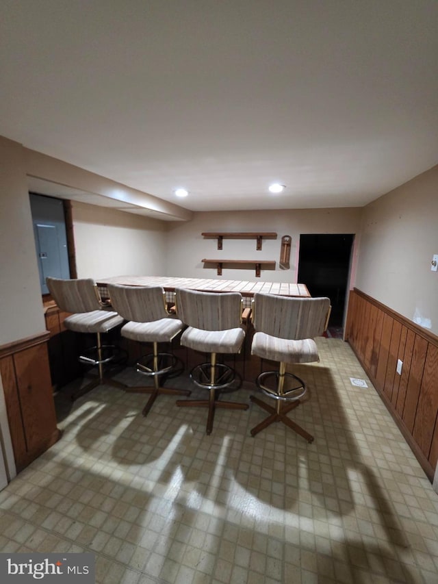 616 Sylvan Pl, Harrisburg, PA 17109 - dining space featuring a wainscoted wall and bar