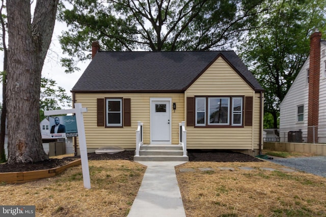 2 Baltimore Ave, Glen Burnie, MD 21061 - bungalow featuring central AC, a chimney, and a shingled roof