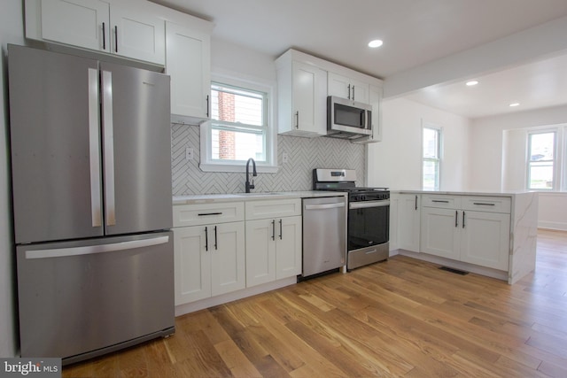 2 Baltimore Ave, Glen Burnie, MD 21061 - kitchen featuring appliances with stainless steel finishes, a sink, a peninsula, light wood finished floors, and recessed lighting