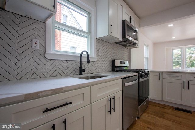 2 Baltimore Ave, Glen Burnie, MD 21061 - kitchen with stainless steel appliances, a sink, tasteful backsplash, white cabinets, and recessed lighting