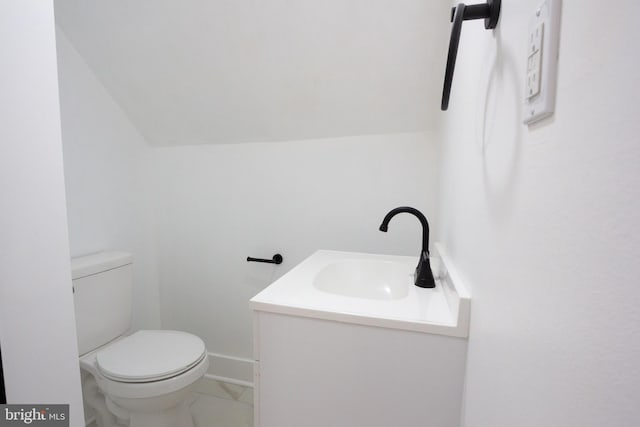2 Baltimore Ave, Glen Burnie, MD 21061 - bathroom with vanity, toilet, lofted ceiling, and baseboards