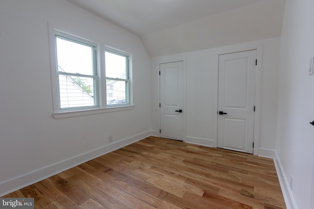 2 Baltimore Ave, Glen Burnie, MD 21061 - unfurnished bedroom featuring vaulted ceiling, light wood-style floors, and baseboards