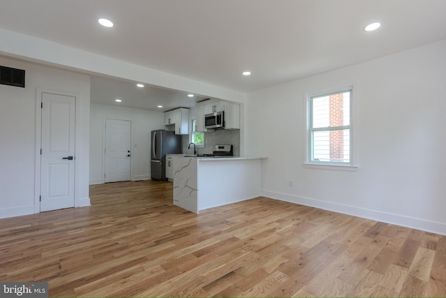 2 Baltimore Ave, Glen Burnie, MD 21061 - kitchen with appliances with stainless steel finishes, white cabinetry, light wood-type flooring, a peninsula, and recessed lighting