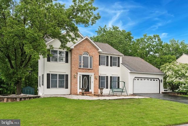 504 Ridge Dr, Douglassville, PA 19518 - view of front facade with driveway, a garage, a front lawn, and a shingled roof