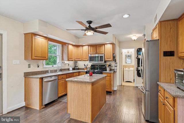 504 Ridge Dr, Douglassville, PA 19518 - kitchen with appliances with stainless steel finishes, a sink, a ceiling fan, a kitchen island, and light stone countertops