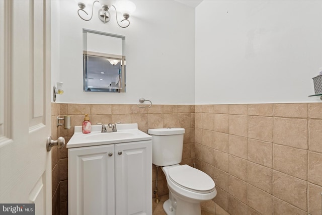 504 Ridge Dr, Douglassville, PA 19518 - bathroom featuring tile walls, vanity, toilet, and wainscoting