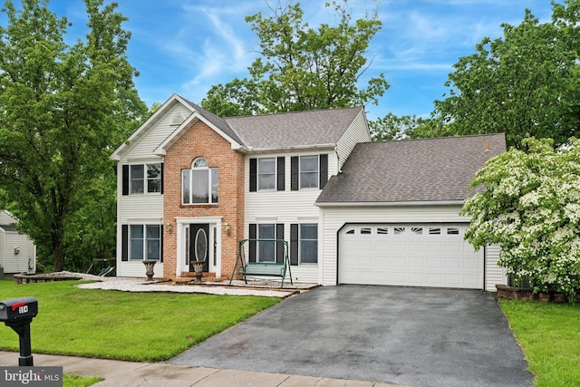 504 Ridge Dr, Douglassville, PA 19518 - colonial house with driveway, a garage, a front lawn, and roof with shingles