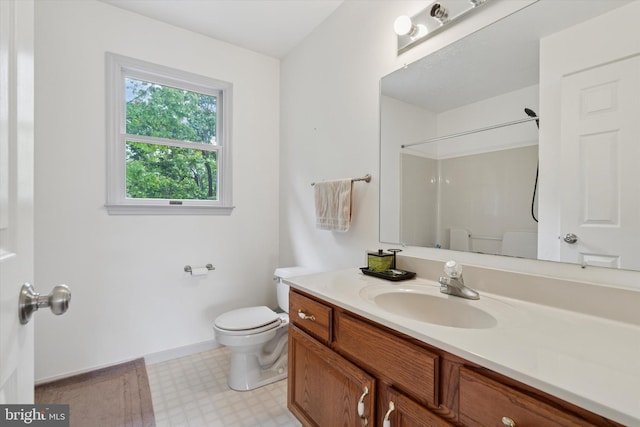 504 Ridge Dr, Douglassville, PA 19518 - full bathroom with toilet, vanity, tile patterned floors, a shower, and baseboards